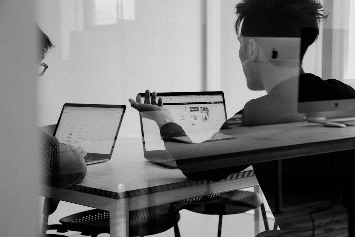 Fintech professionals reviewing dashboards on a laptop screen